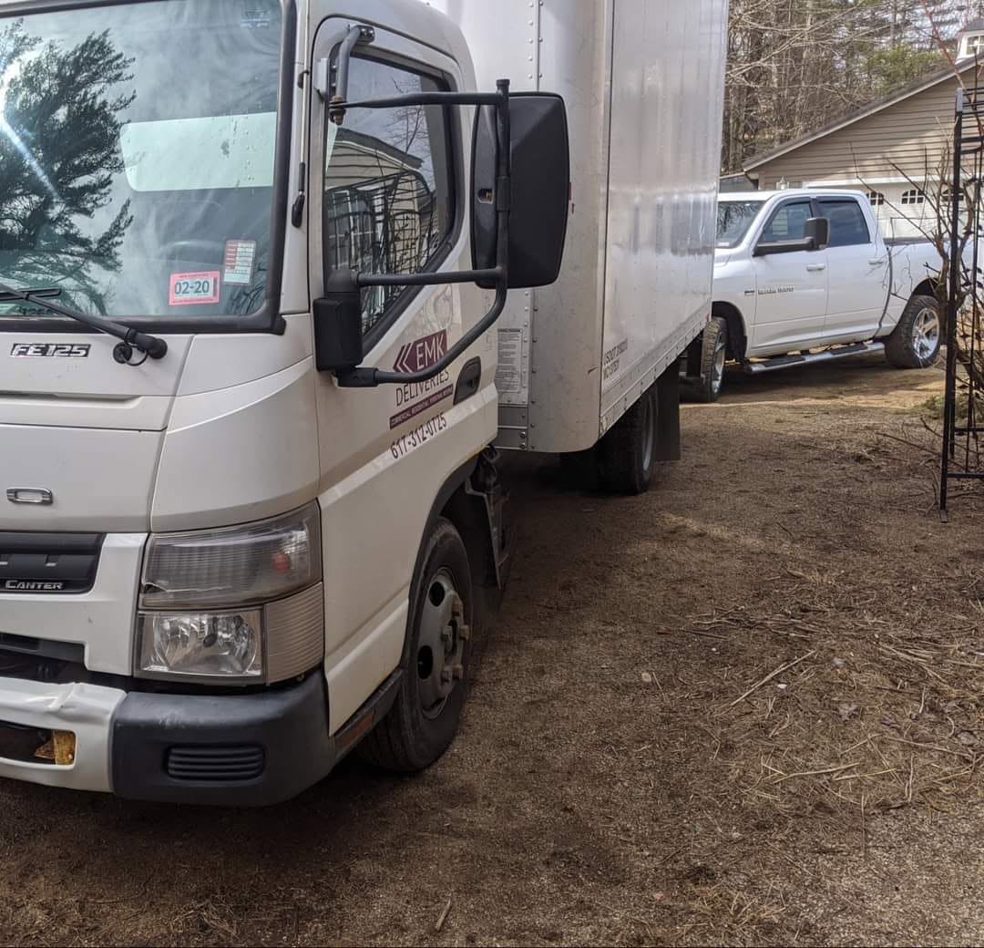 EMK Deliveries truck lettered with the EMK logo and phone number